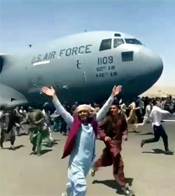 Afghans chasing departing U.S. cargo plane at Kabul Airport