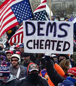 Trump supporters, one holding sign "Dems Cheated"