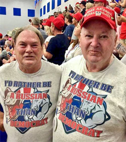 Two men at a Trump rally wearing "I'D RATHER BE A RUSSIAN THAN A DEMOCRAT" t-shirts