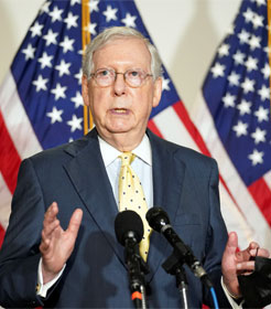 Mitch McConnell in front of American flags