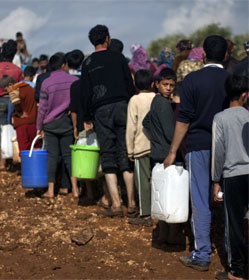 Syrian refugees in line for water