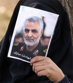 Iranian mourner holding photo of Gen. Soleimani