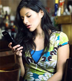 Woman staring at phone--visualphotos.com