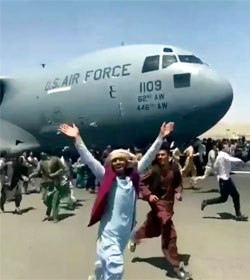 Afghans chasing departing U.S. cargo plane at Kabul Airport