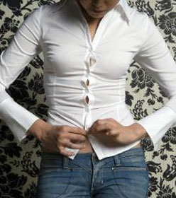 Woman trying on too-small shirt