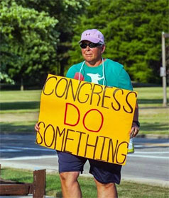 Man holding sign, "Congress Do Something"
