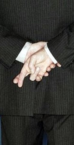 Man crossing fingers