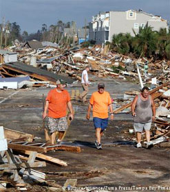 Three men walking through town destroyed by hurricane