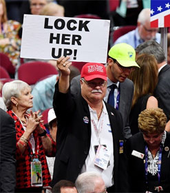 Trump supporter holding "Lock Her Up" sign