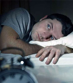 Man awake in bed at night