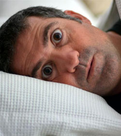 Man lying awake in bed
