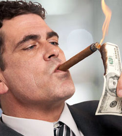 Man lighting cigar with hundred dollar bill
