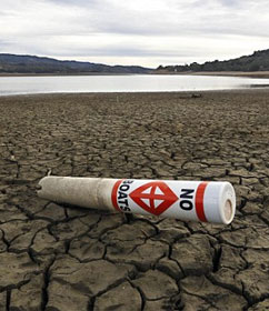 "No boats" sign on parched lakebed