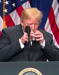 Donald Trump drinking water with two hands