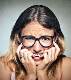 Nervous woman biting her nails
