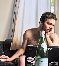 Despondent man working on laptop